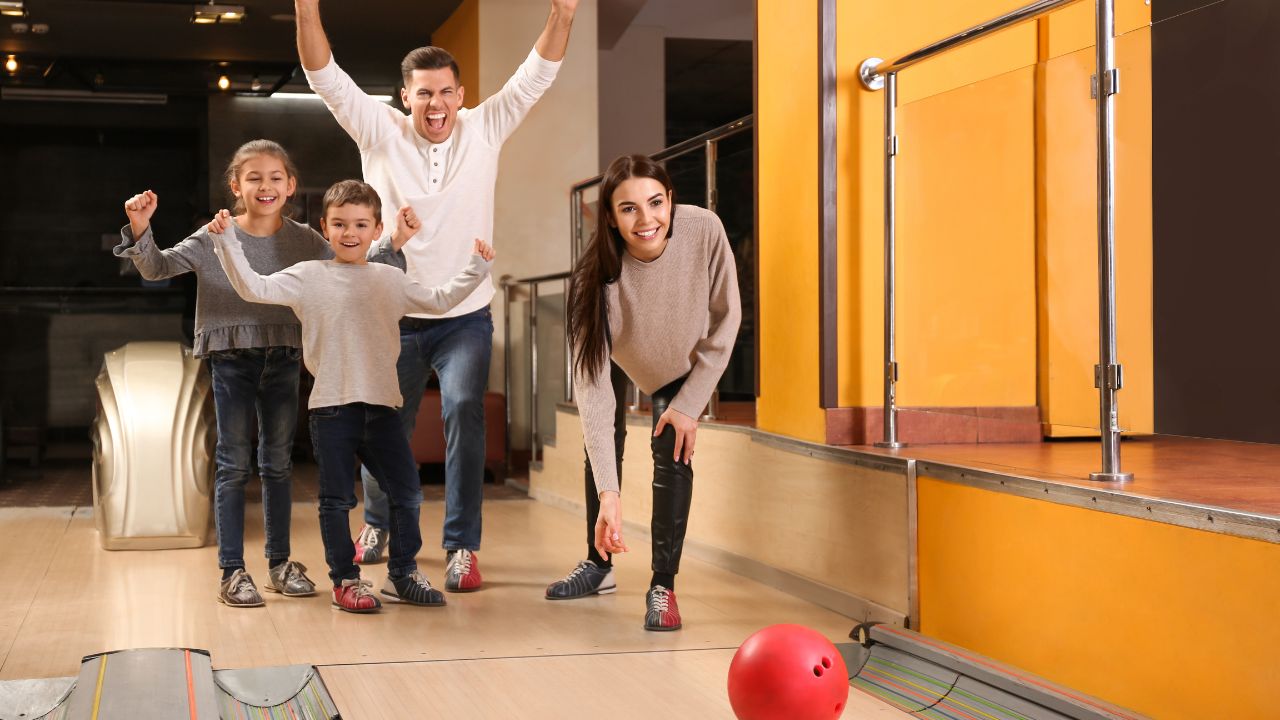 Family enjoying bowling at an indoor entertainment centre in Dubai.