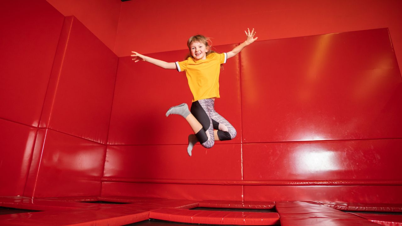 Happy child jumping on an indoor trampoline in Dubai, enjoying family activities.