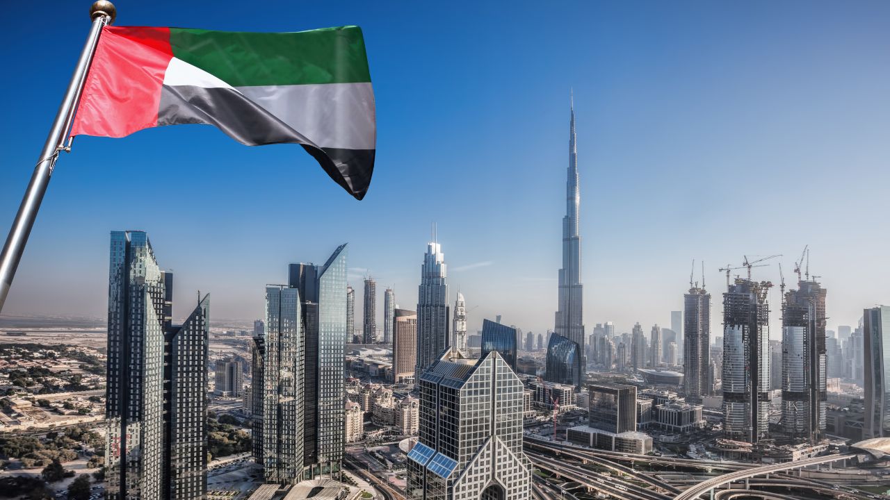 Dubai skyline with Burj Khalifa and UAE flag during Art Run event.