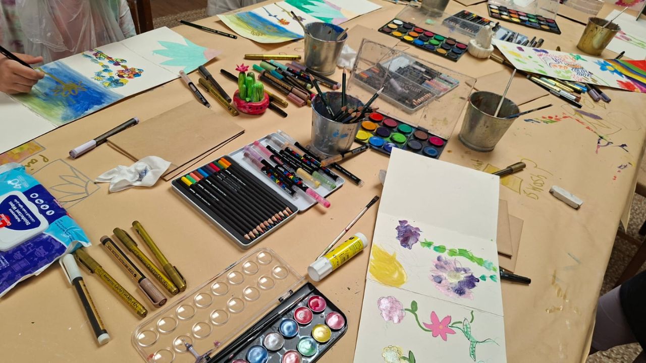messy table filed with art stuff