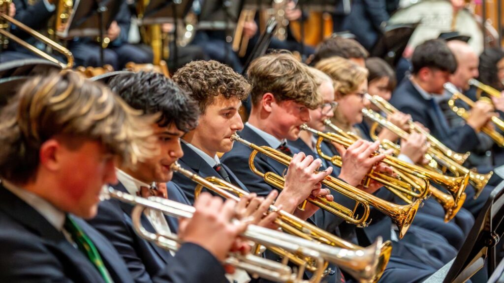 Students playing trumpets in a school orchestra at Rugby School Dubai