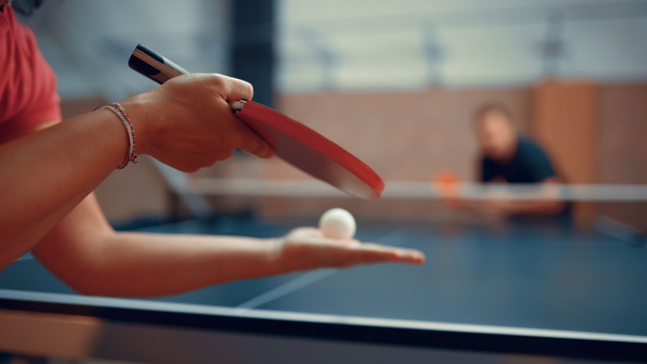 table tennis players serving the ball