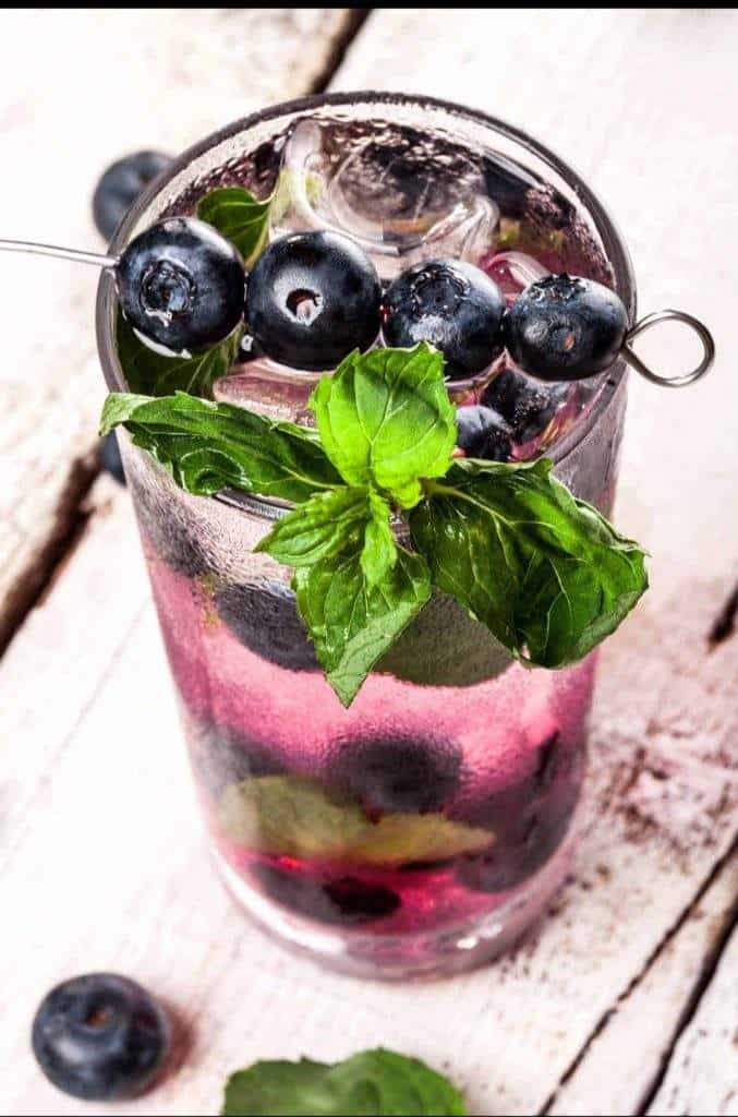 Blueberry Lemon Basil Mojito garnished with fresh basil and lemon slice