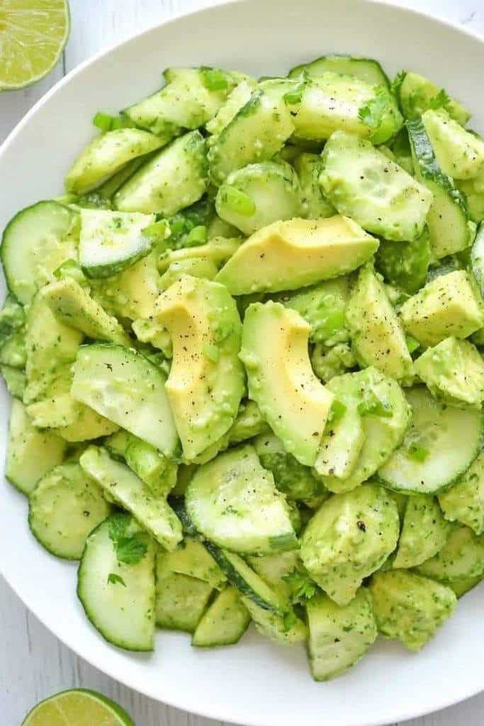 "Creamy avocado cucumber salad with fresh cilantro, lime dressing, and Greek yogurt served in a bowl