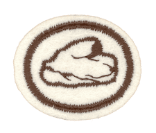 Wohlfühlteppich mit Schneckenmotiv in Creme und Braun, perfekt für gemütliche Räume und Kinderzimmer.