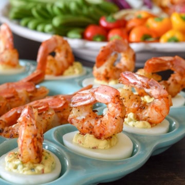 A tray of deviled eggs with shrimp.