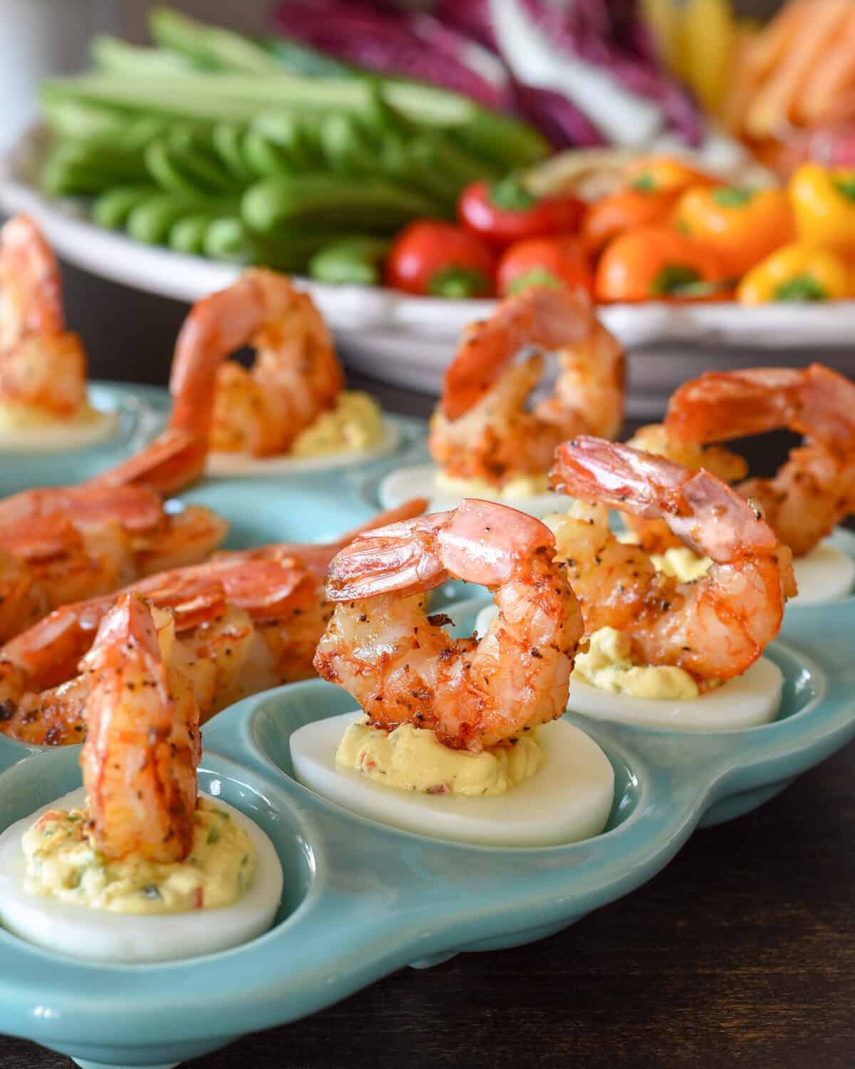 A tray of deviled eggs with shrimp.