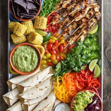 grilled chicken skewers, tortillas, peppers, jalapeños, corn, cucumber and tortilla chips.