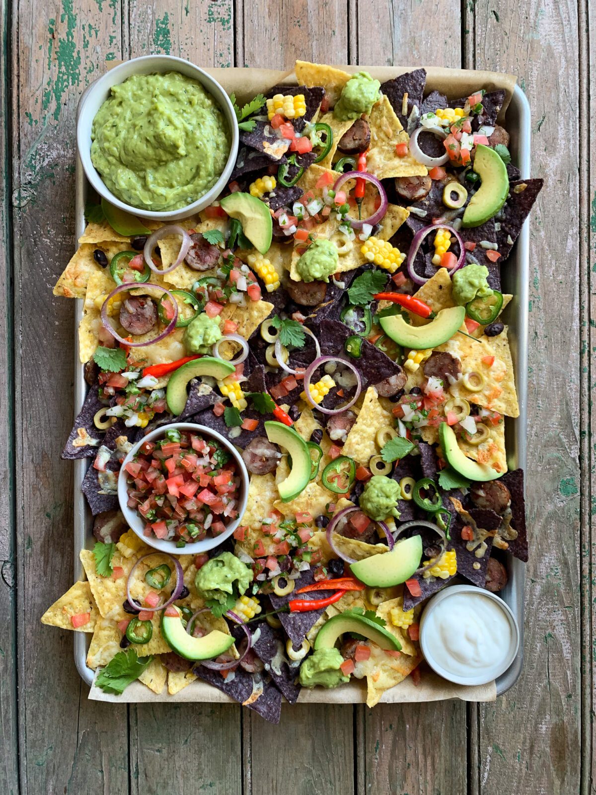Nacho platter with fresh guacamole and Pico de Gallo and all the fixings.