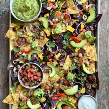 Nacho platter with fresh guacamole and Pico de Gallo and all the fixings.