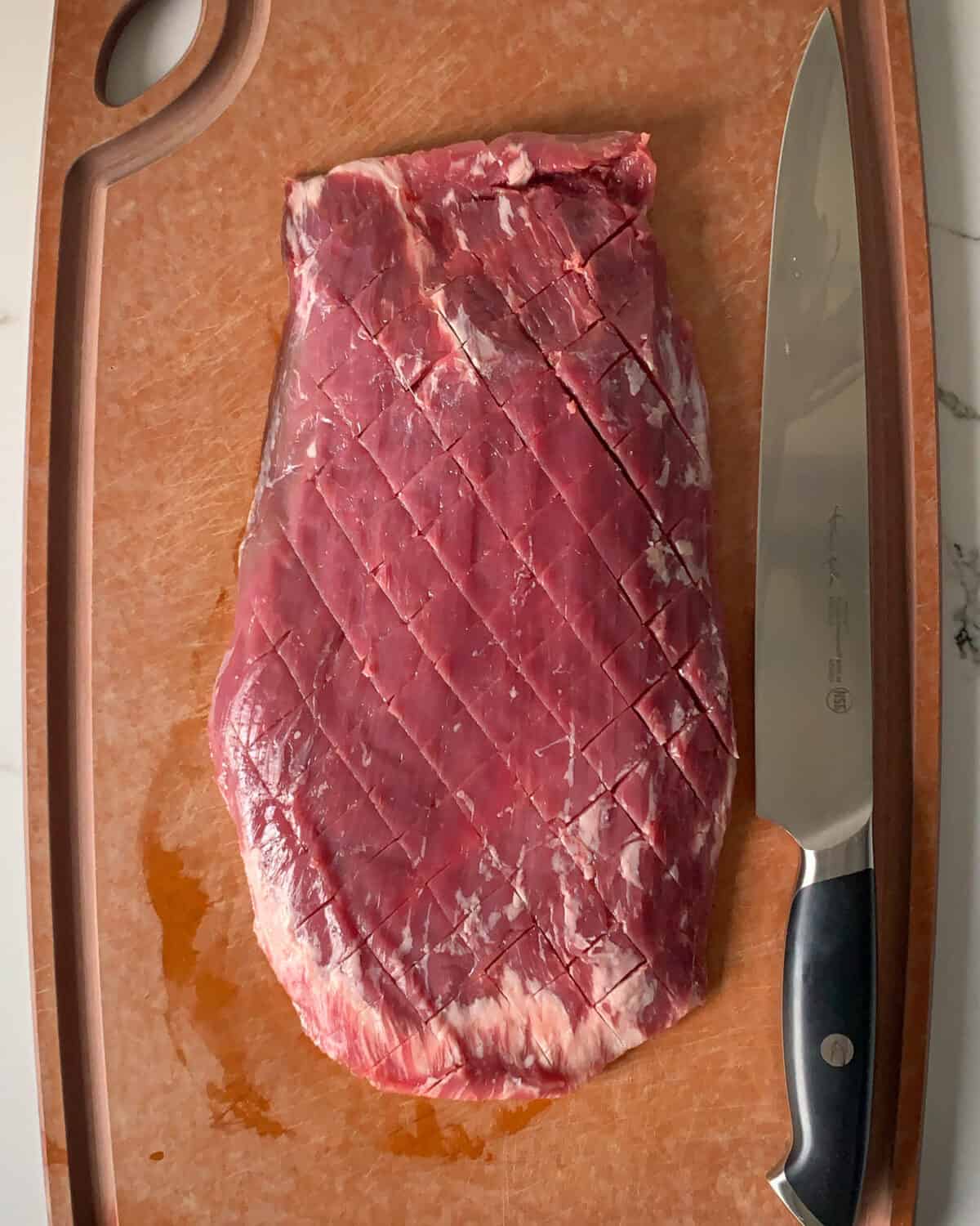 This shows how to properly score your flank steak with a knife before marinating.