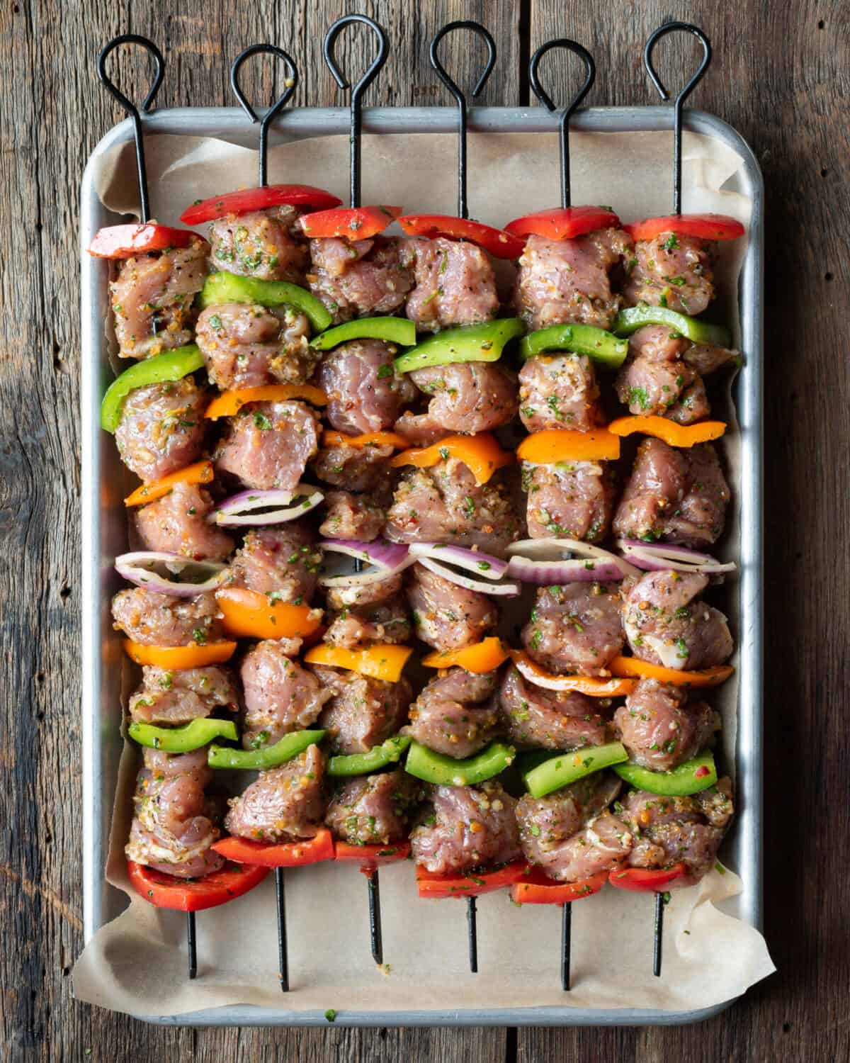 Prepped skewers on a tray ready for the grill.