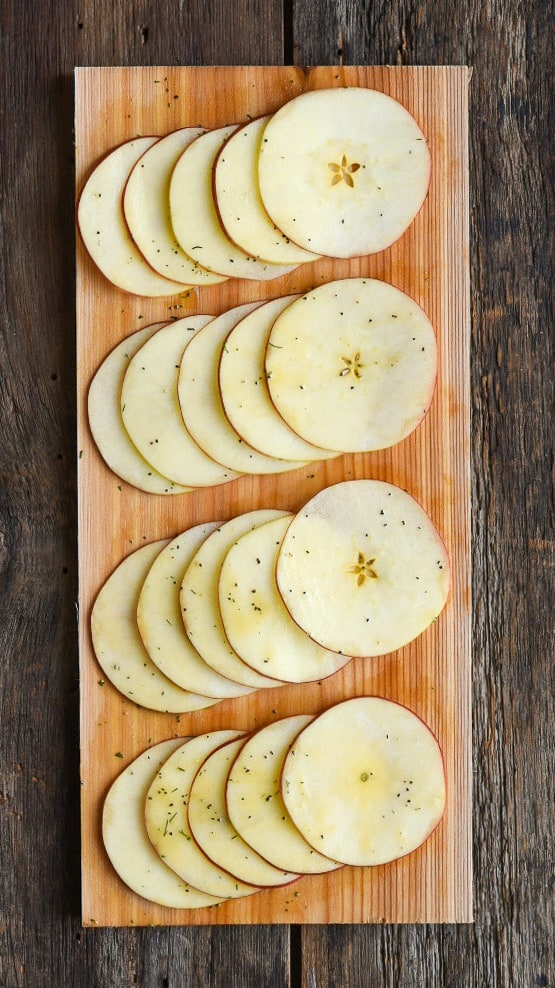 This shows how the thinly sliced apples should be placed on the cedar planked salmon dish.