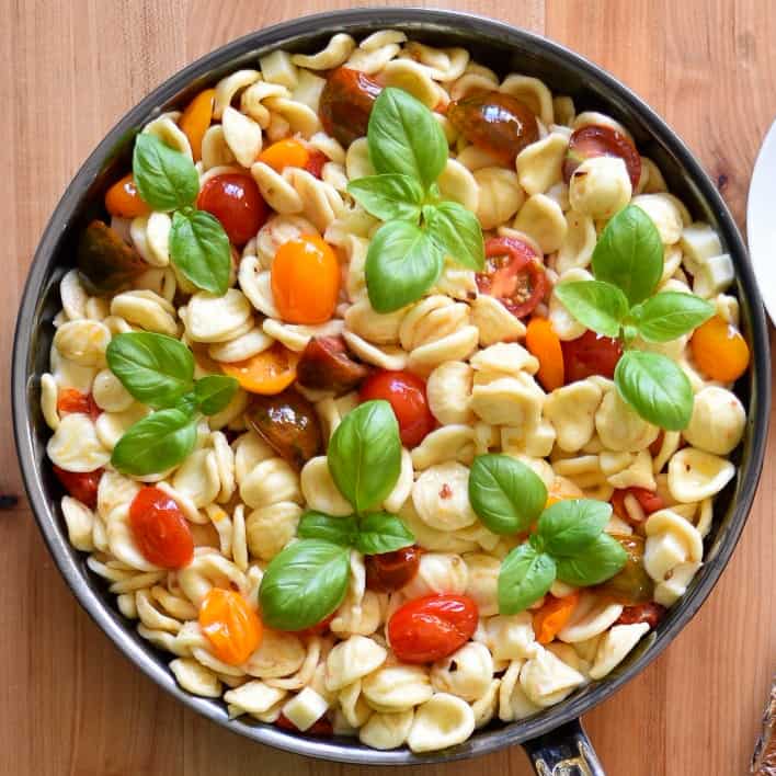 A large pan of Orecchiette with Heirloom Tomatoes, Mozzarella and basil.