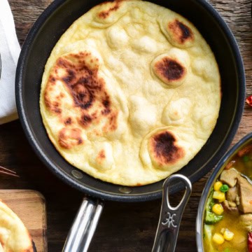 A skillet with a baked flatbread.