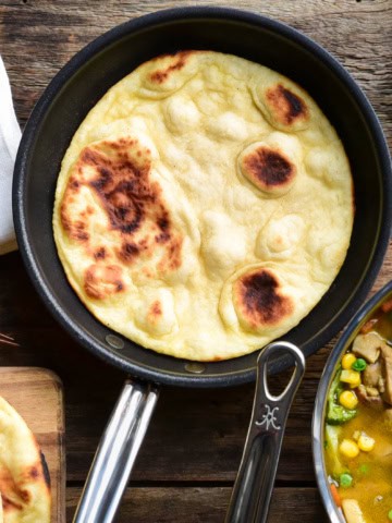A skillet with a baked flatbread.