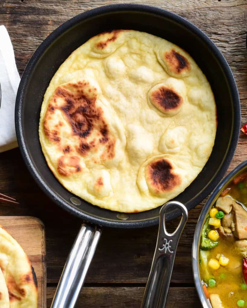 A skillet with a baked flatbread.