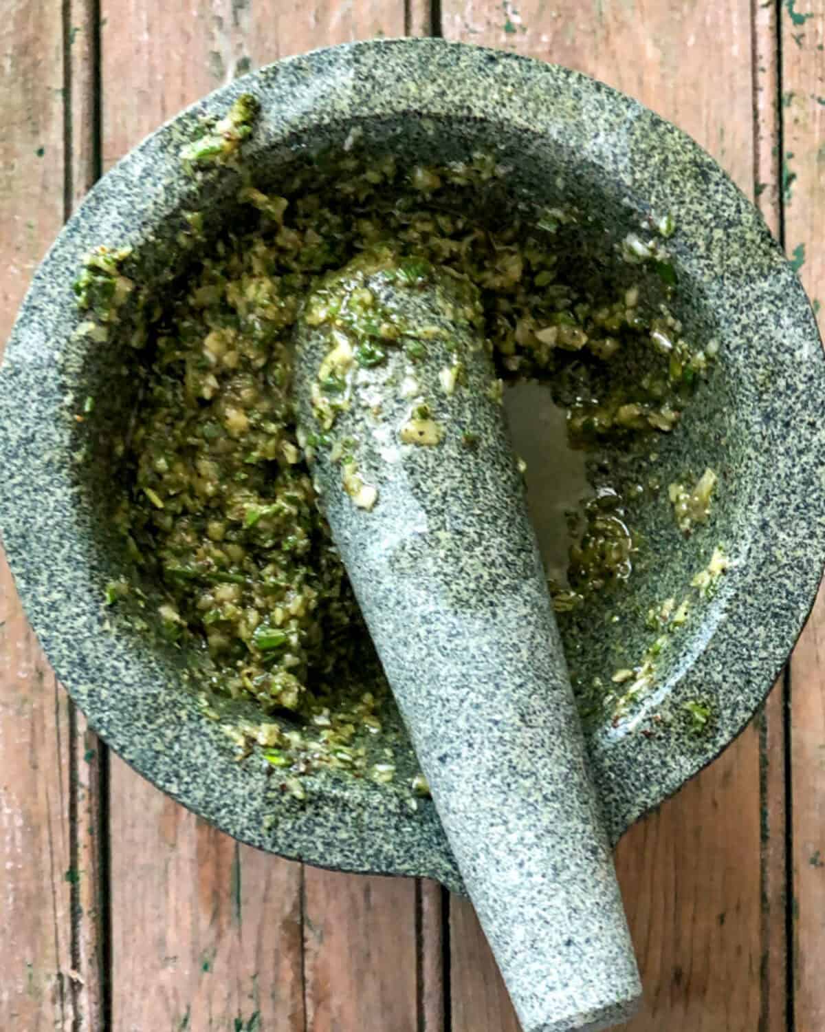 Pound garlic to a paste with sea salt using a mortar & pestle, then stir in the rosemary, thyme, pepper, and olive oil.