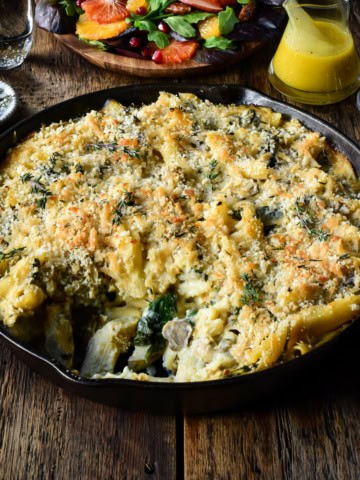 A cast-iron skillet with a creamy cauliflower pasta bake.