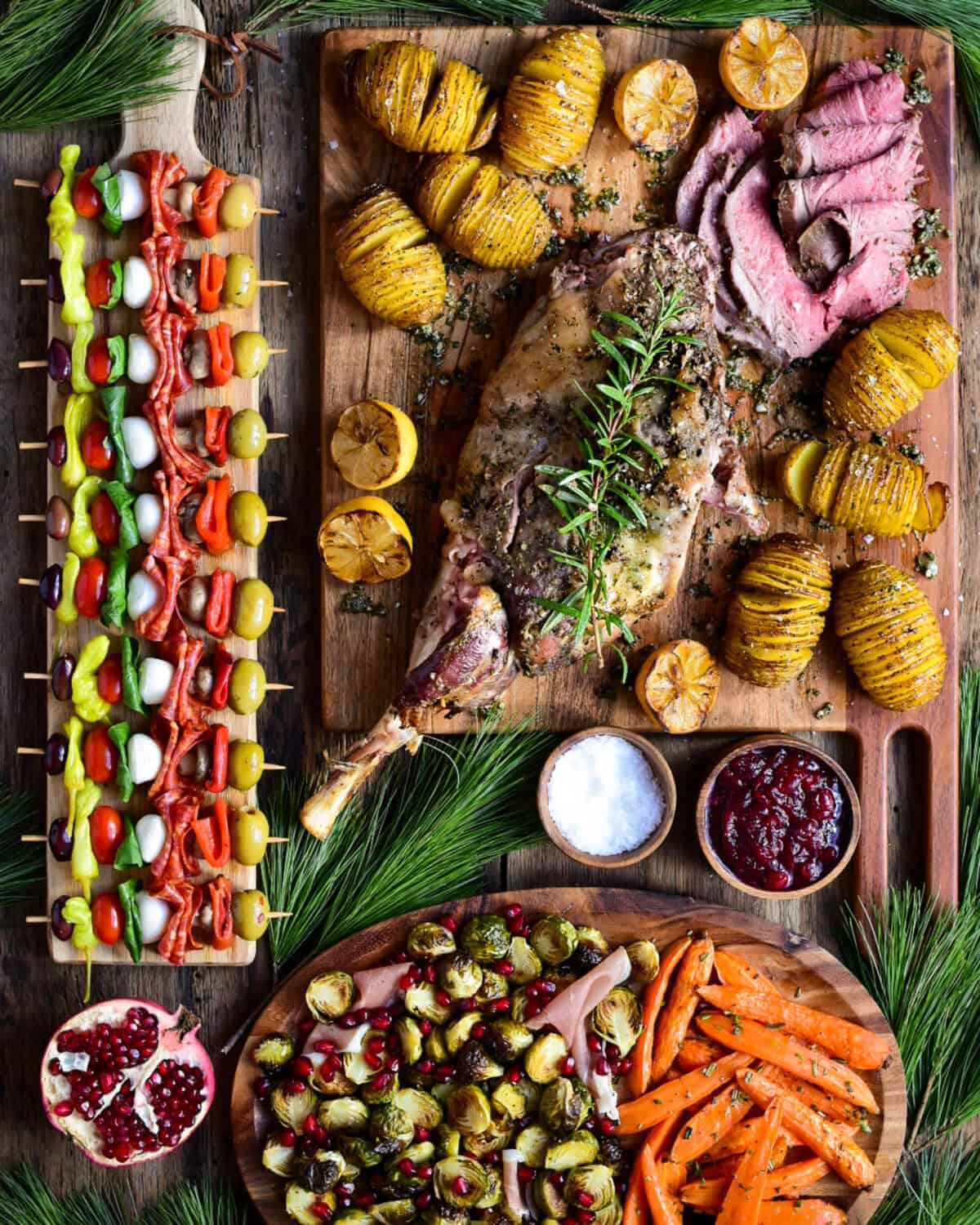 Served with traditional cranberry sauce (because lamb and cranberries are a perfect match), crispy hasselback potatoes, roasted carrots with rosemary and Brussels sprouts with ribbons of prosciutto, then sprinkled with festive pomegranate arils.