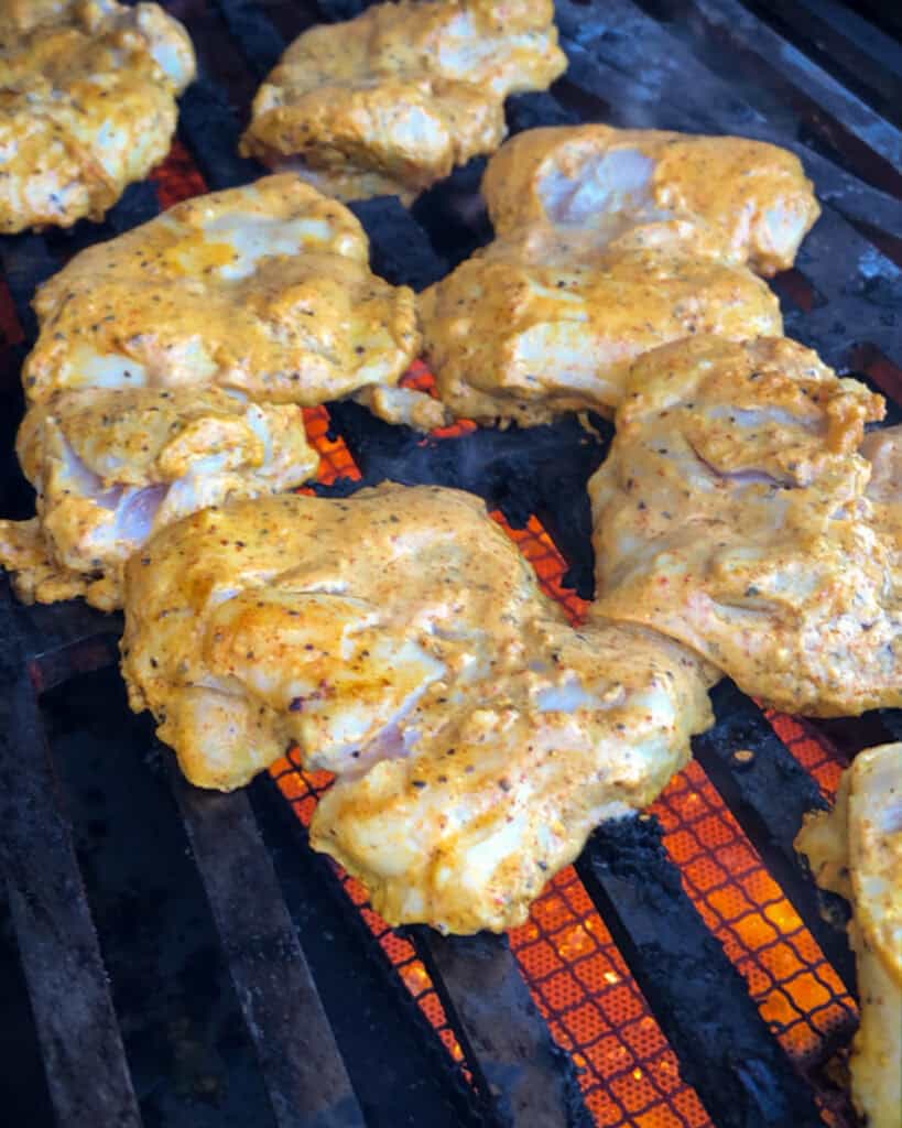 Chicken thighs going on the grill.