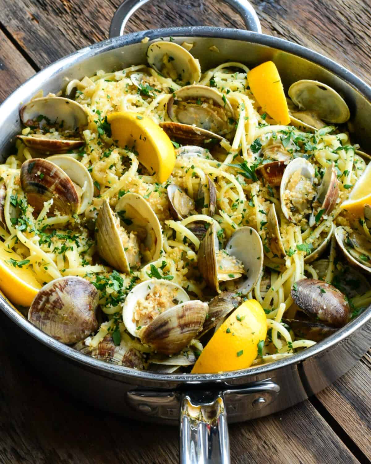 Serve in the sauté pan, topped with more breadcrumbs, red pepper flakes, remaining parsley, a drizzle of olive oil and lemon wedges.
