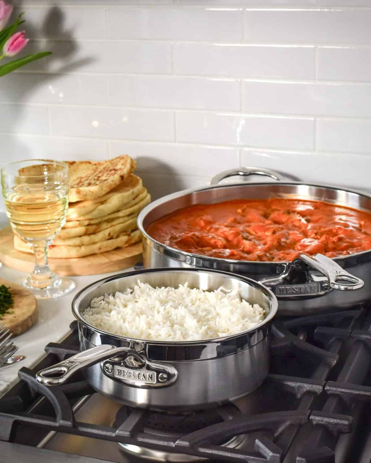A pot of grilled chicken tikka masala and a pot of rice.