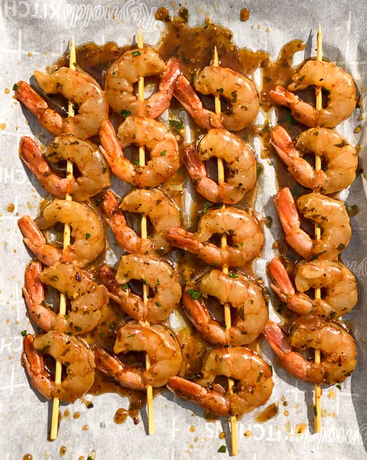 Four sweet and spicy shrimp skewers ready to go on the grill.