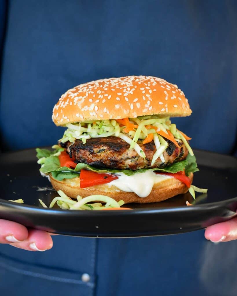 A side view of a turkey kale & feta burger.