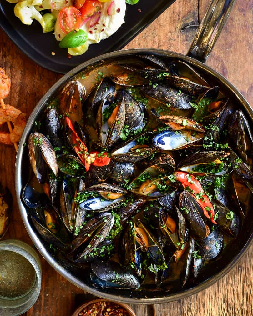 A skillet of Red Thai Curry Mussels.