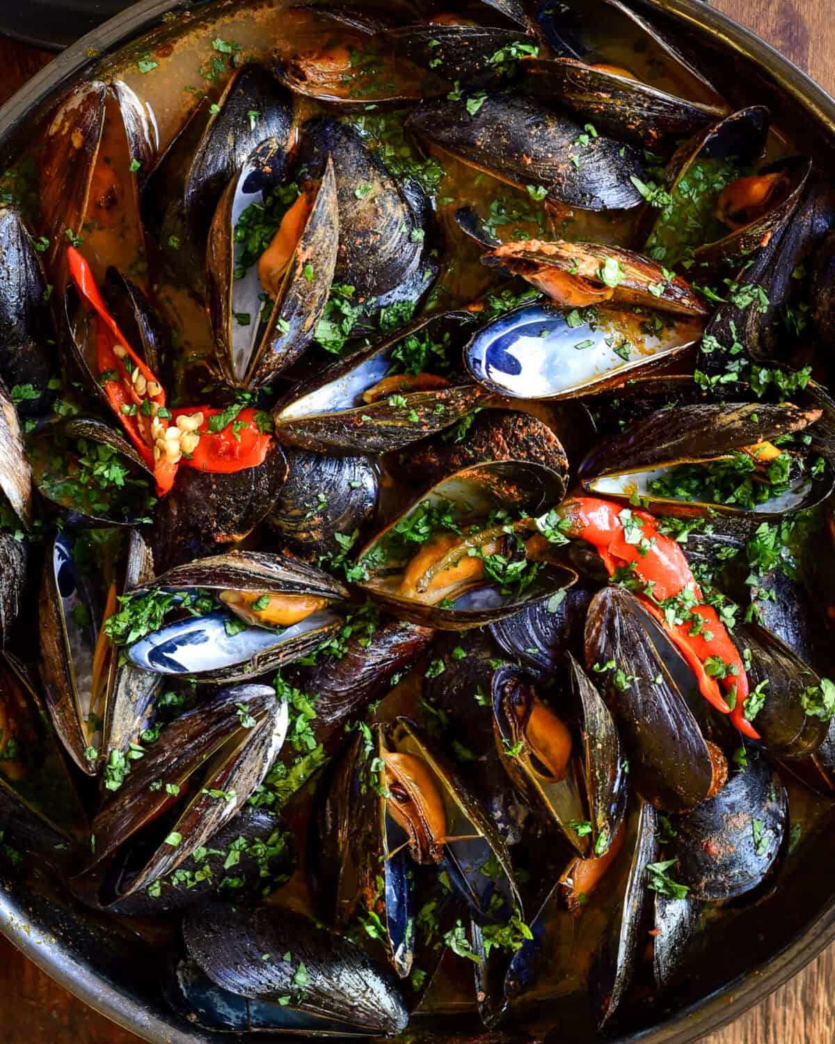 A close up of Red Thai Curry Mussels