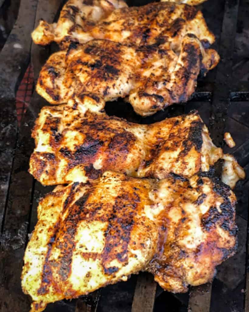 Grilled chicken thighs on the grill.