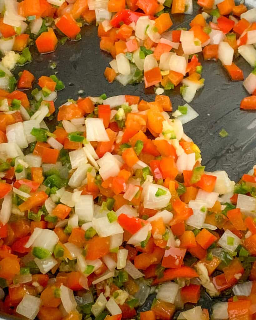 Sauté onions, bell peppers and garlic.