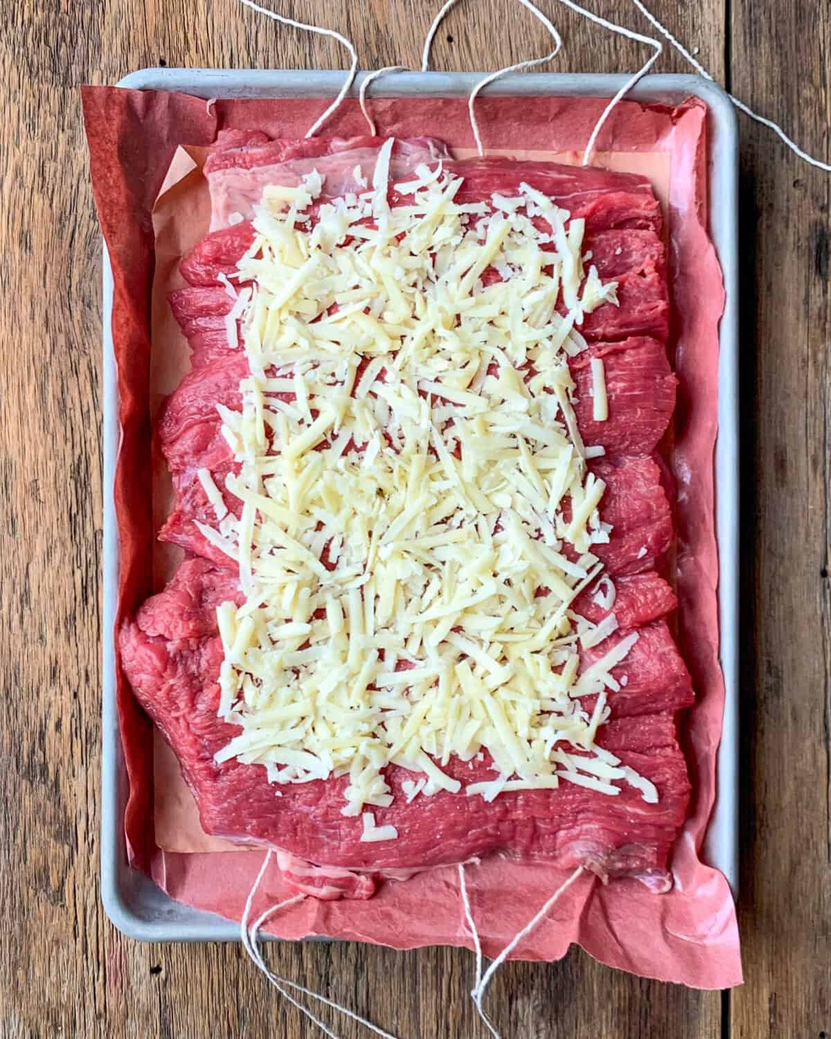 Sprinkle the cheese evenly over the flattened roast.