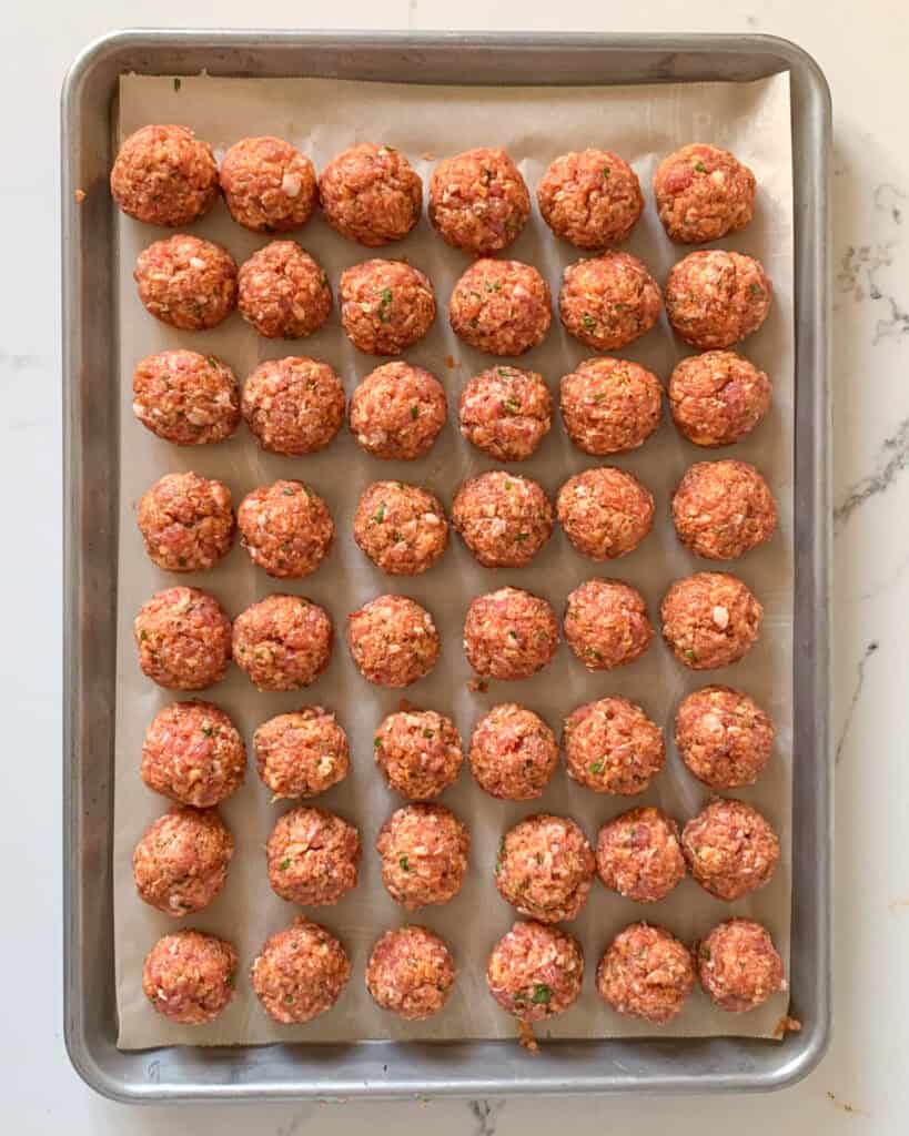 Form 3 cm (1 ¼ inch) meatballs (approximately 28.5 g/1 oz) and place on a parchment lined baking sheet.