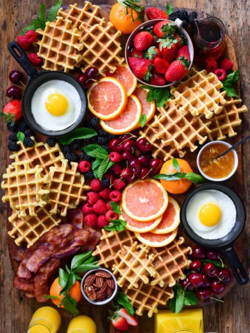 Buttermilk waffles served with fresh berries, cara cara oranges, thick-cut bacon, fried eggs and local maple syrup.