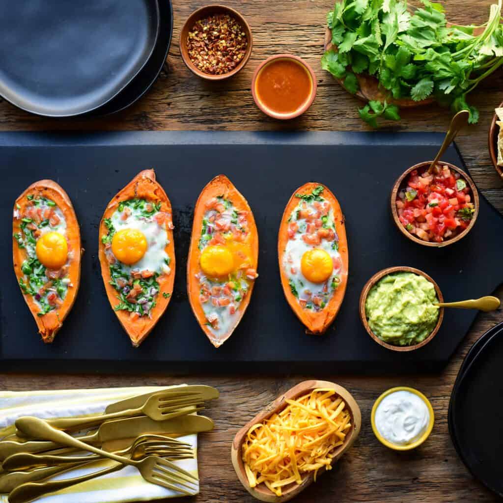Finished sweet potato boats surrounded by taco fixings