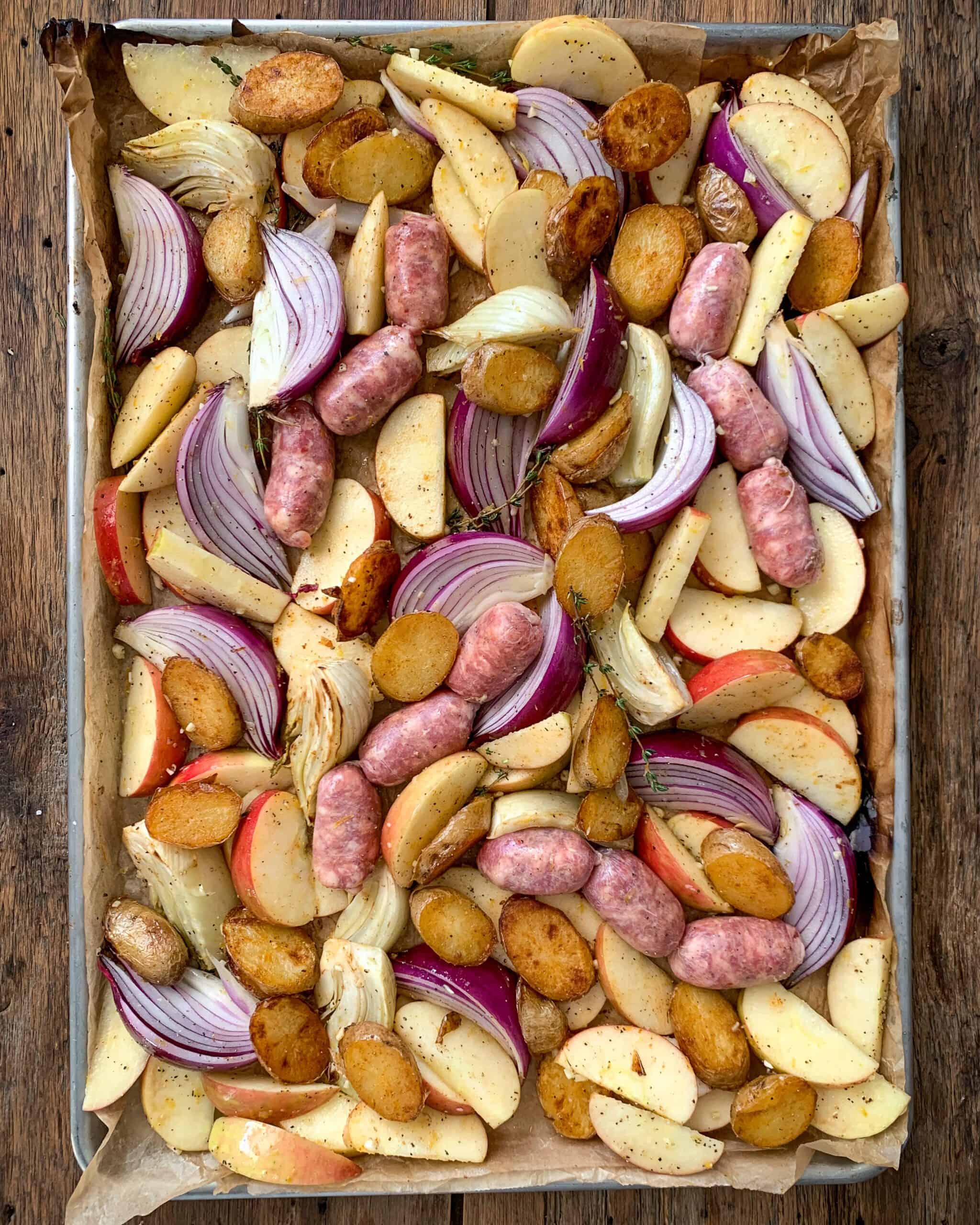 Spread out into a single layer on the baking sheet. Nestle the sausages into the mixture.