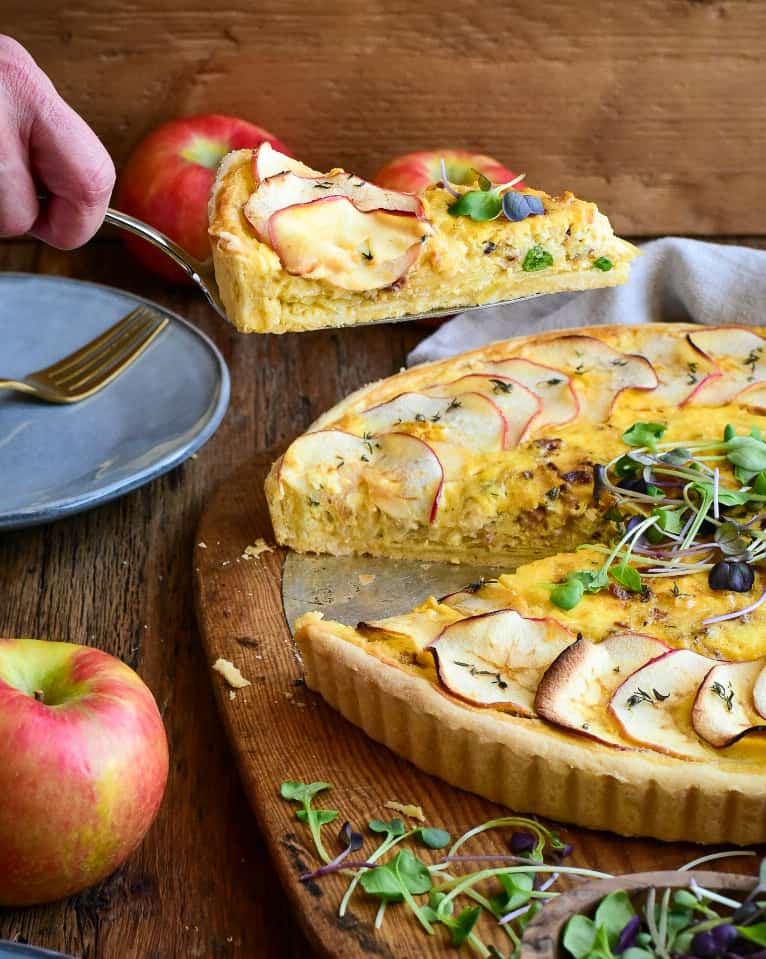 A slice of quiche showing the layers.