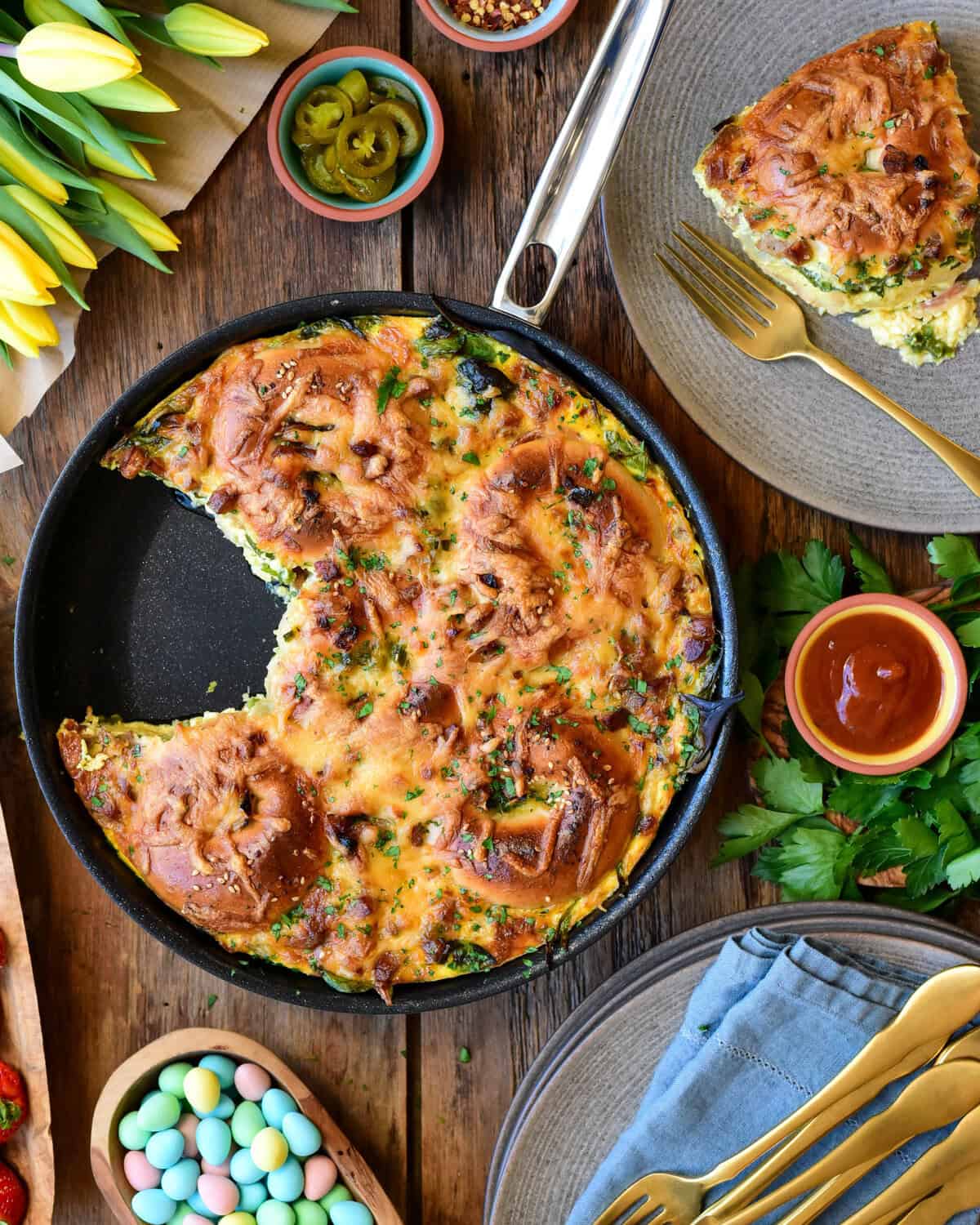 A bagel bake skillet bake with a piece removed and on a plate.