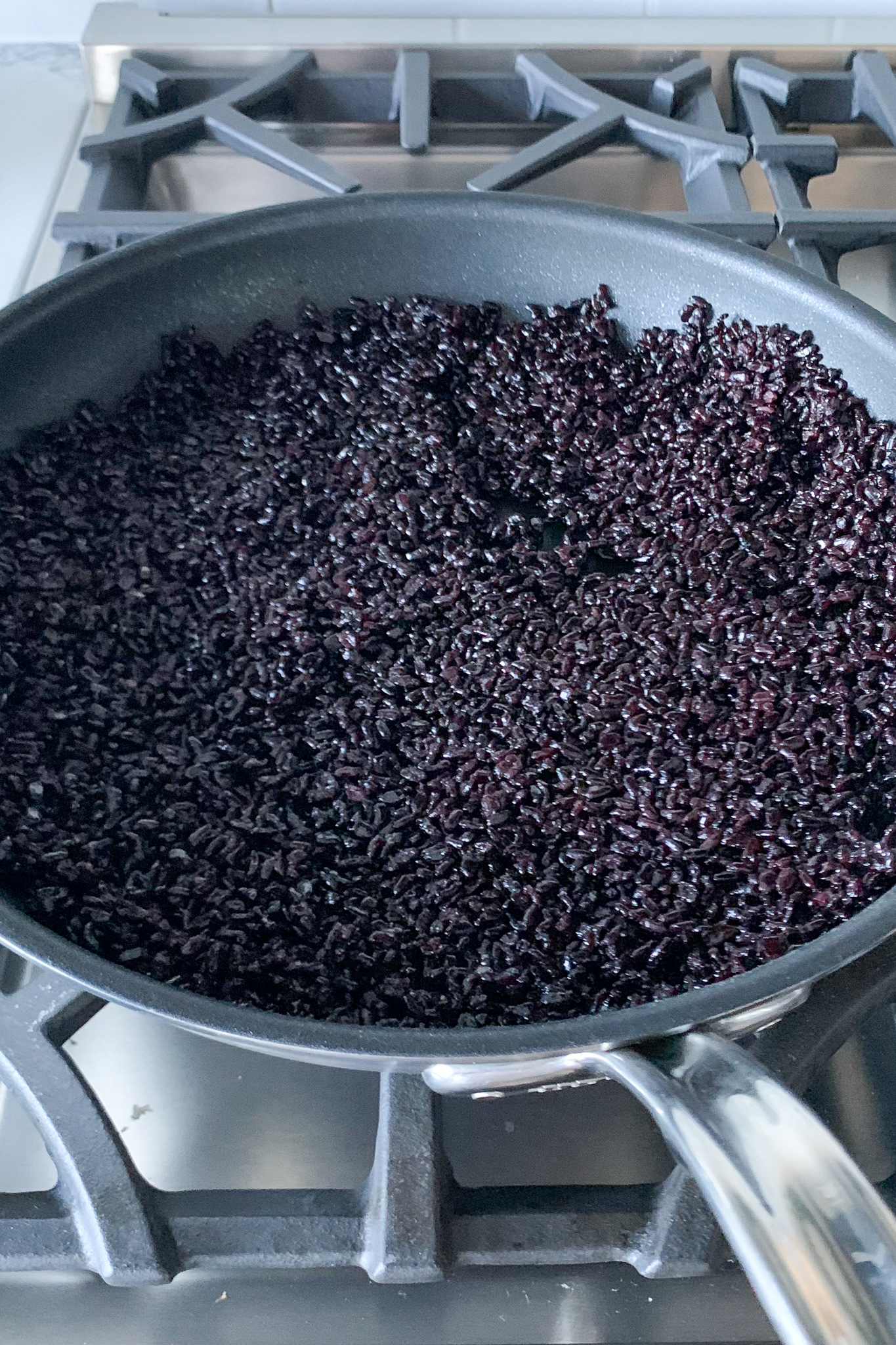 A skillet of stir fried black rice
