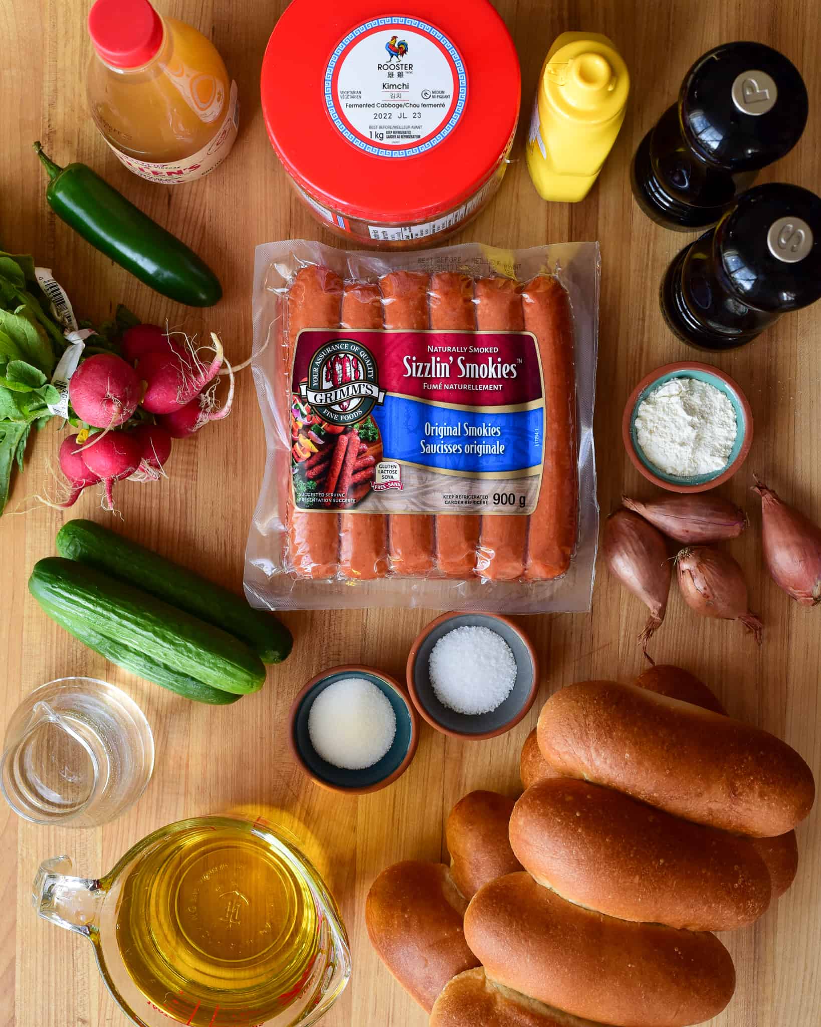 A flat lay of ingredients for Smokies with Kimchi, Pickled Veggies & Crispy Shallots