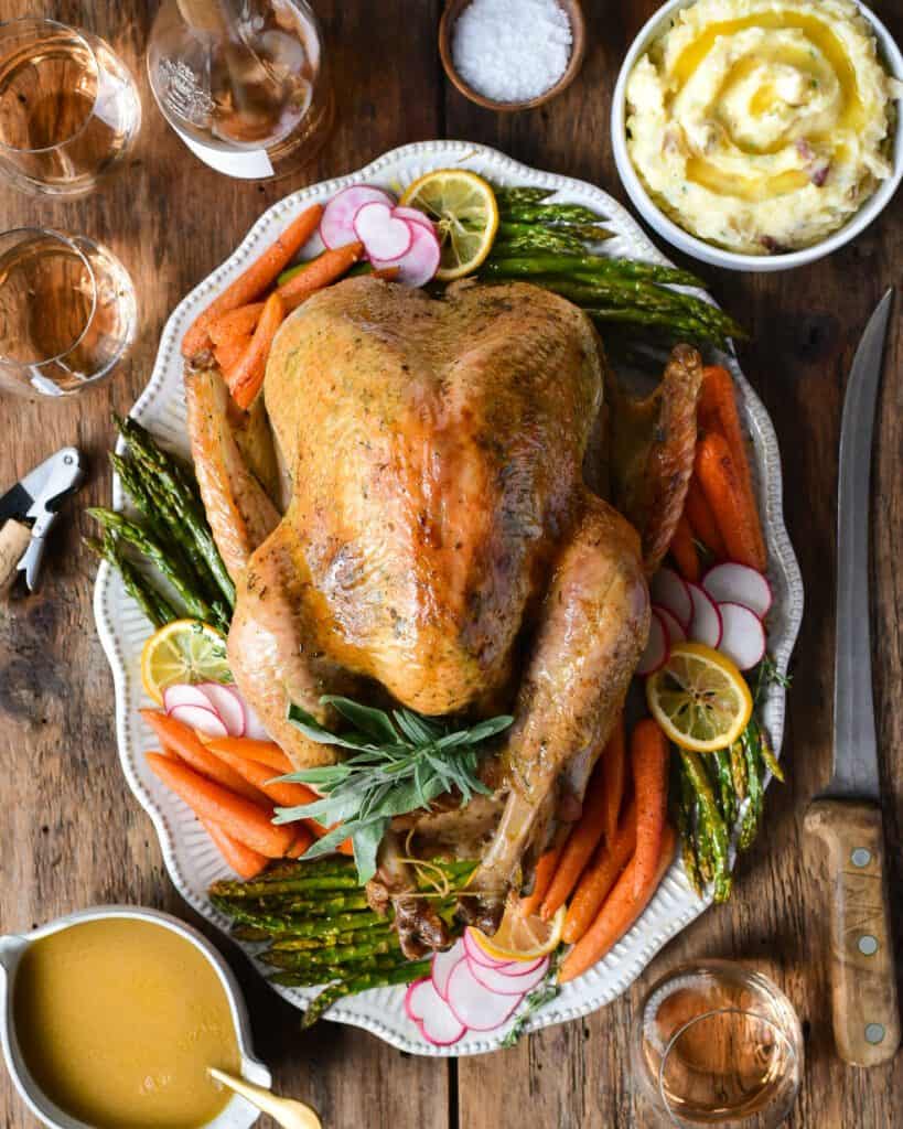A plater of turkey with sides of spring asparagus with lemon, roasted carrots, spring mix salad, brioche dinner rolls and a chilled rosé, rounded out the meal.