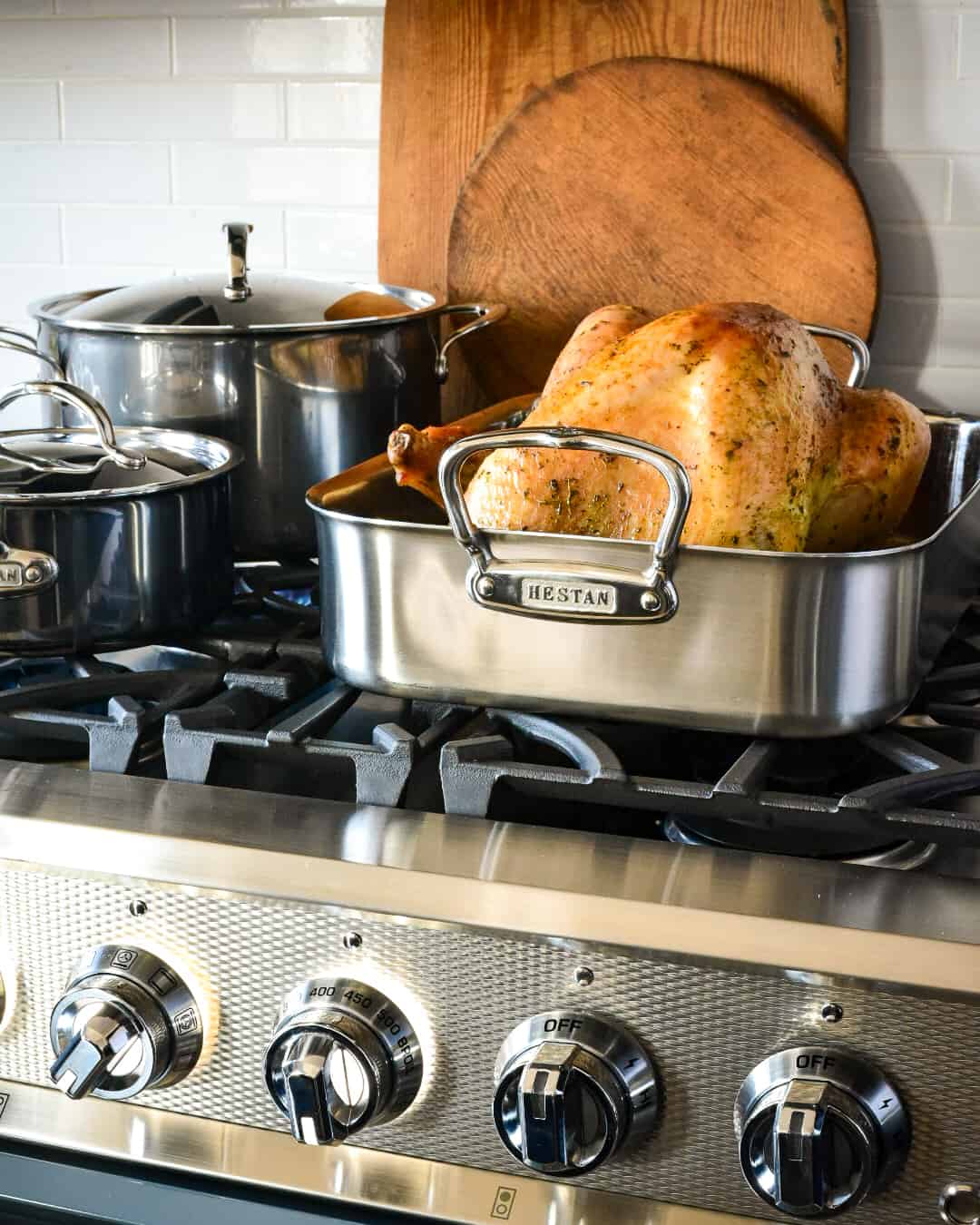 A finished turkey in the roasted resting on the oven.