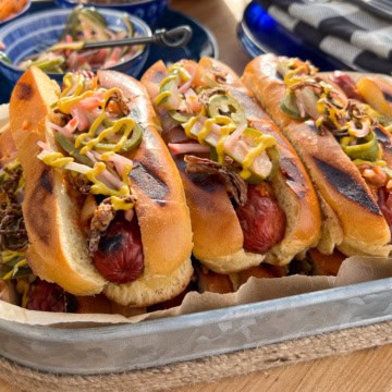 A close-up image of a stack of smokies with all the fixings.