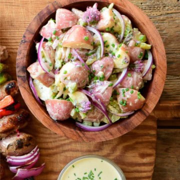 A dill pickle salad in a wooden bowl.