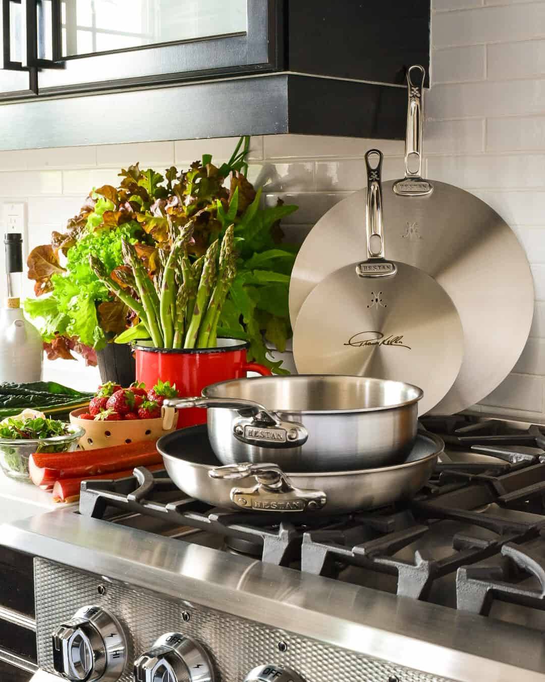 Ingredients laid out beside a range with the skillet, pan and lids ready.