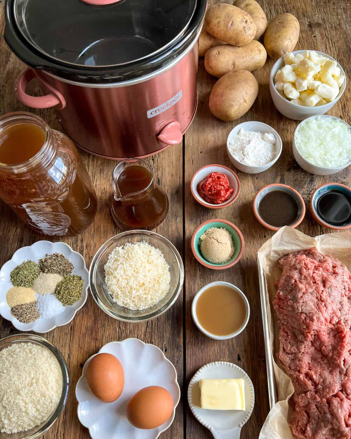 Ingredients measured and laid out beside a copper slow cooker.