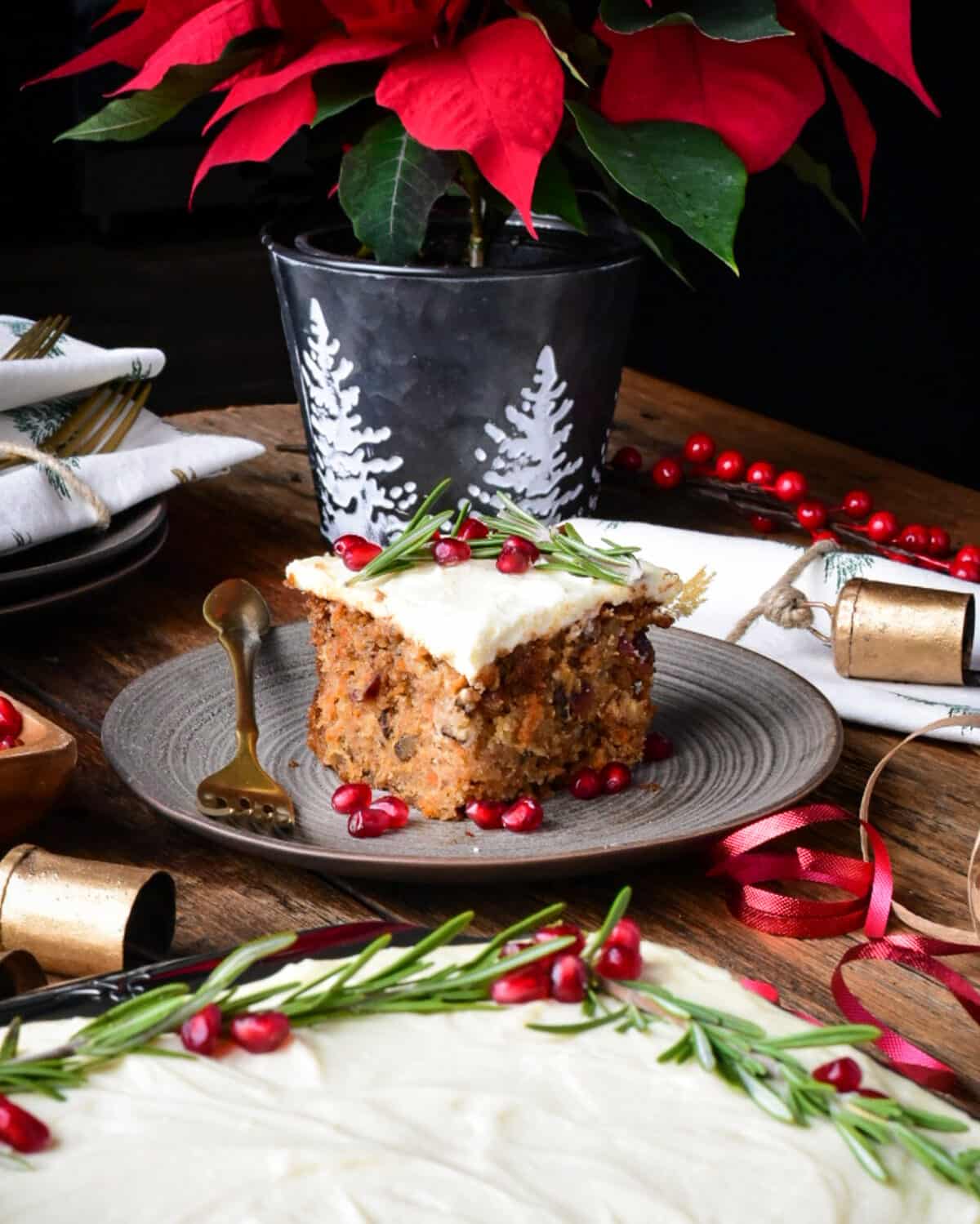 A close up of a square festive piece of cake with cream cheese icing.