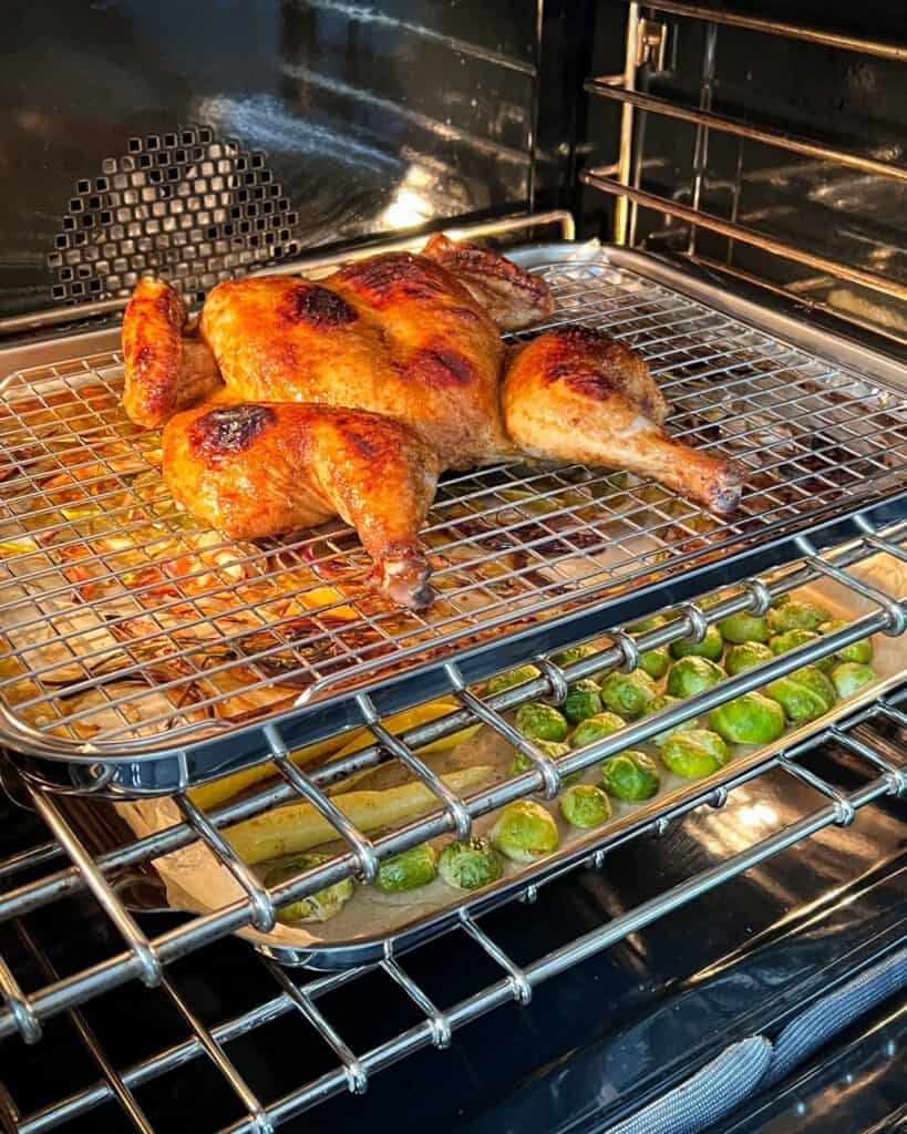 Spatchcock chicken on a rack in the oven.